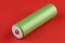 18650 battery green on red background