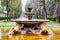 18th century Fontana dei Cavalli Marini stands in the middle of a round plaza surrounded by trees and walkways at Via Pinciana