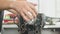 19.07.2018 Chernivtsi - worker is disassembling car engine in a repair shop, twisting bolts and detaching details with