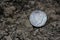 1922 Silver Peace Dollar On Ground in Dirt. Front View