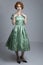1950`s woman in green satin dress