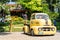 The 1951 Yellow colored Ford COE pickup truck with custom wheels parking at the car park ,