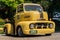 The 1951 Yellow colored Ford COE pickup truck with custom wheels parking at the car park ,