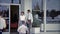 1959: Car saleman opening door for lady and child. MIAMI, FLORIDA