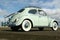 1965 Volkswagen beetle with clouds in the sky
