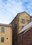 19th century stone warehouse and factory buildings in bradford west yorkshire against a blue cloudy sky