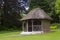 The 19th Century thatched summer house surrounded by beautiful flower beds and gravel paths in the walled garden at West Dean