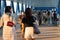 2 4 2021 a lady walks in blurred crowd with face masks in Central, Hong Kong in Slanted sunlight at dusk. hard to keep social