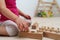 A 2.5 year old child sorts shapes of different sizes. Wood childrens game by Montessori system. ]]