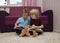 2 barefoot preschool boys are looking at and reading a book together