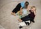 2 barefoot preschool boys play together with multi-colored mosaic, sitting on rug