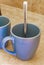 2 blue coffee cups and black coffee maker from Mexico