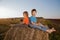 2 boys in a haystack in the field