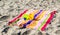 2 child`s sand pails and shovels on a striped beach towel