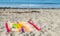 2 child`s sand pails and shovels on a striped beach towel at the ocean