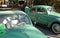 2 Classic Volkswagen Beetles Lined Up in Row Color Green