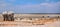 2 Elephants facing a waterhole with many different species in the background