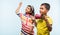 2 indian kids flying kite, one holding spindal or chakri