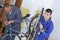 2 men repairing bicycles in workshop