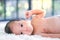 2-month-old babies lie on the white cloth and the morning sun