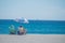 2 people in beach chairs on the sand on a beach in Florida