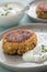 2 Plates with vegetarian oatmeal cottage cheese patty with herbal quark dip