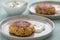 2 Plates with vegetarian oatmeal cottage cheese patty with herbal quark dip