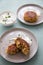 2 Plates with vegetarian oatmeal cottage cheese patty with herbal quark dip