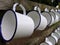 2 rows of white enamel mugs