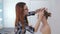 2 shots. Professional hairdresser doing hairstyle for teen girl