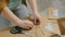 2 shots. Two professional women decorators making envelopes at workshop