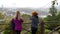 2 Turkish women looking at Istanbul skyline with Fatih Sultan Mehmet Bridge.