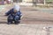 A 2 -year-old boy painting with chalk outdoors