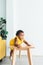 A 2-year-old Nigerian baby girl with beautiful curly hair, climbing a table with a mischievous