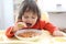 2 years boy eating soup red-beet soup