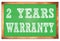 2 YEARS WARRANTY words on green wooden frame school blackboard