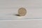 A 20 centimes Swiss coin standing on a wooden background