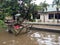 20 February 2021, Dirt Rust Trash Cart submerged in flood at condet East Jakarta, Indonesia while flooding