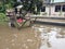 20 February 2021, Dirt Rust Trash Cart submerged in flood at condet East Jakarta, Indonesia while flooding