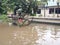 20 February 2021, Dirt Rust Trash Cart submerged in flood at condet East Jakarta, Indonesia while flooding