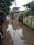 20 February 2021, Motorcyle acrossing Flooding small street at Condet East Jakarta, Indonesia