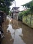 20 February 2021, Motorcyle acrossing Flooding small street at Condet East Jakarta, Indonesia