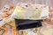 200 euros and a black men`s wallet on a background of euro banknotes. Much money. Cash background.