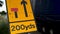 200 yards roadworks warning sign on UK motorway at evening with traffic passing