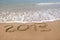 2013 year wrote on the beach, with copy space