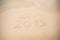 2014 and 2015 write on white sand