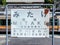 2016 May 05. TOKYO JAPAN. An old white rusty metal information board which had Japanese kanji letter word as MITAKE Station