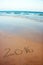 2016 written in sand on tropical beach