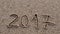 2017 new year written in sand, on tropical beach