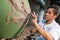 2017 October 1 Ratchaburi, Thailand. man worker how they made Dragon clay on pot water in pottery workshop